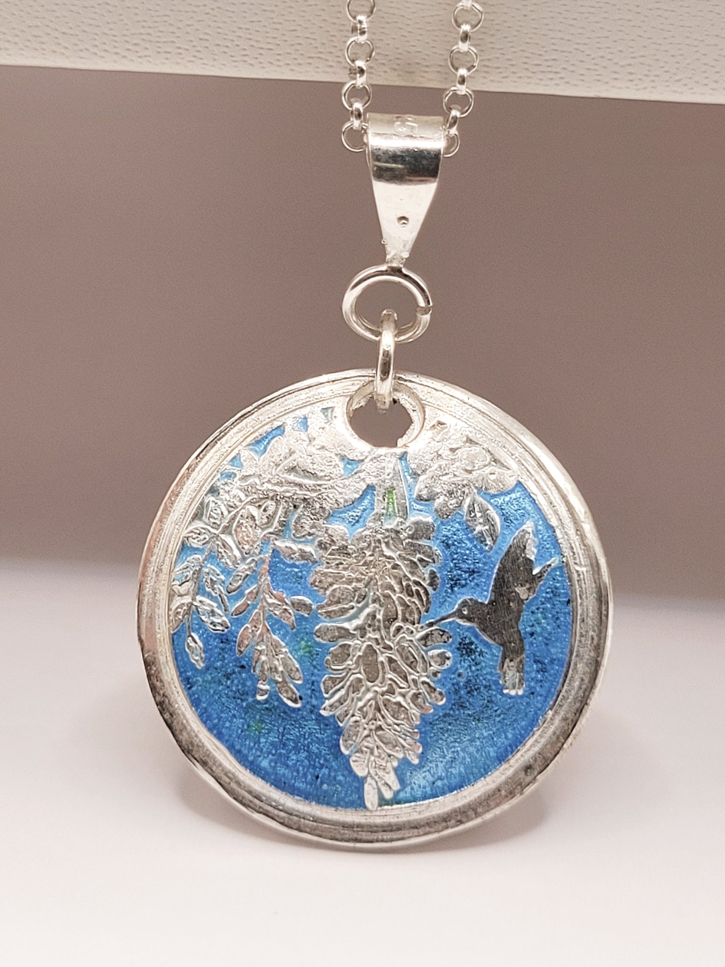 pendentif champlevé en émail sur argent fin représentant un papillon sphynx dans les glycines. Emaux translucides. Bijou artisanal maison Calub les émaux du luberon made in France